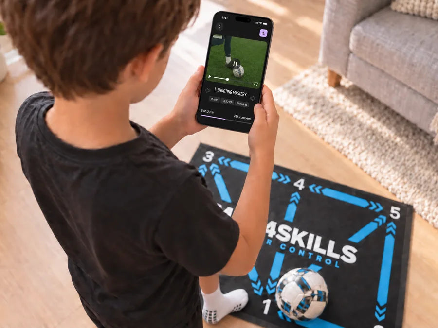 A child standing on the Mat4Skills mat holding a phone with a drill open in the app